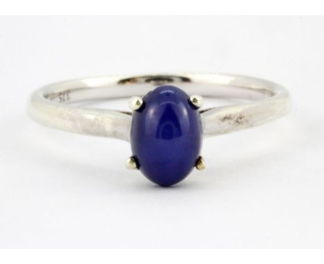 A 9ct white gold ring set with a cabochon star sapphire, (M.5).