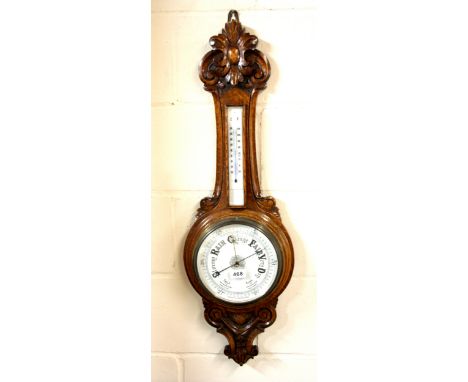 A carved oak banjo barometer, H. 90cm.