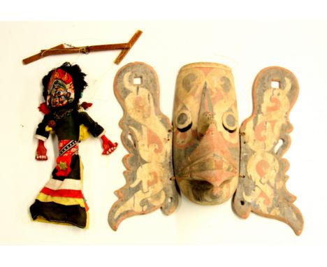 A Indonesian hand painted wooden Garuda mask and a double headed Indonesian puppet, mask H. 38cm.