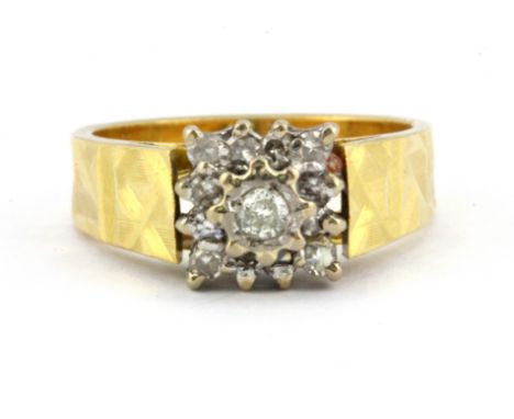 An 18ct yellow and white gold diamond set cluster ring, (M).