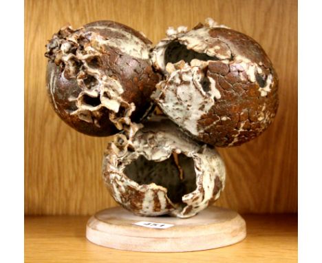 An interesting studio pottery ceramic sculpture on a wooden base, H. 23cm.