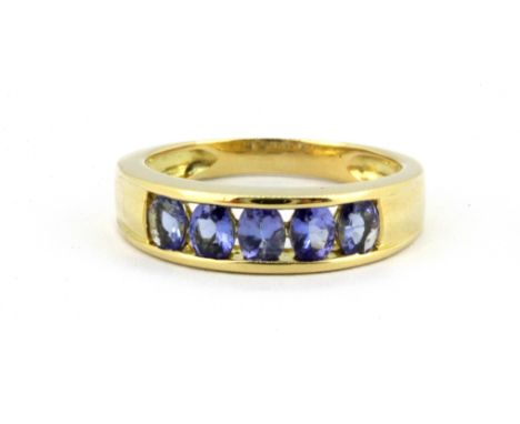 An 18ct yellow gold ring set with oval cut tanzanites, (L).