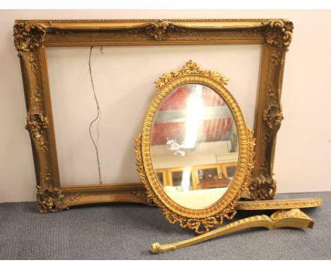 A large gilt gesso frame, size 130 x 100 x 9cm, together with a gilt gesso framed oval mirror, H. 86cm and a gilt console tab