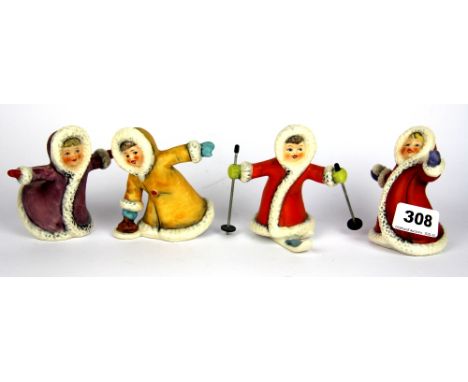 Four Goebel children figurines in snow, H. 9cm.