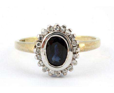 A 9ct yellow and white gold sapphire and diamond set cluster ring, (R.5).