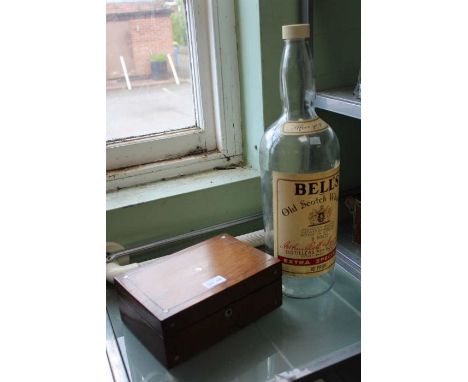 A Bells old scotch whisky eight pint empty bottle with a Victorian rosewood box