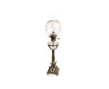 VICTORIAN OIL LAMP, the cut glass reservoir above a fluted brass pillar over an ornately pierced and cast squareform base, on