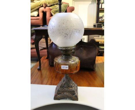 An oil lamp, etched shade (no chimney)