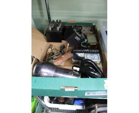 A box of miscellaneous items, including vintage nutcrackers, playing cards, electrical testers, etc.