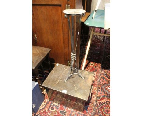 A metal floor standing candlestick together with a metal coal box