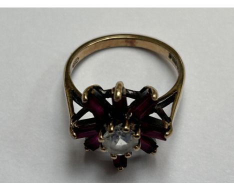 9ct Gold dress ring set with white central stone & 7 pink gem stones Size L Weight 3.1g