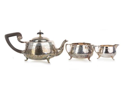 ARTS & CRAFTS HAMMERED SILVER TEA SERVICE, BARKER BROTHERS, CHESTER 1922 comprising a teapot, sugar and cream, each of ovoid 