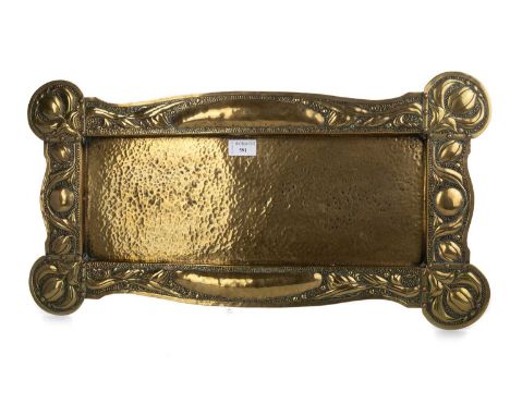 ART NOUVEAU HAMMERED BRASS TRAY, CIRCA 1900 of shaped oblong form, repousse with border of stylised tulips and bosses62cm wid