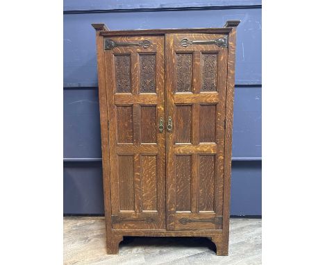 IN THE MANNER OF SHAPLAND & PETTER FOR WYLIE & LOCHHEAD, ARTS & CRAFTS OAK WARDROBE, CIRCA 1900 the moulded cornice over twin