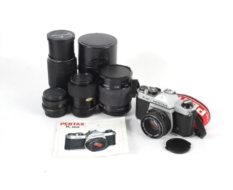 An Asahi Pentax K1000 and five lenses. To include a 50mm 1:2 Pentax M, a 70-200mm 1:4 Pentax A, a 24mm 1:2.8 Cosinon-W, a 35-