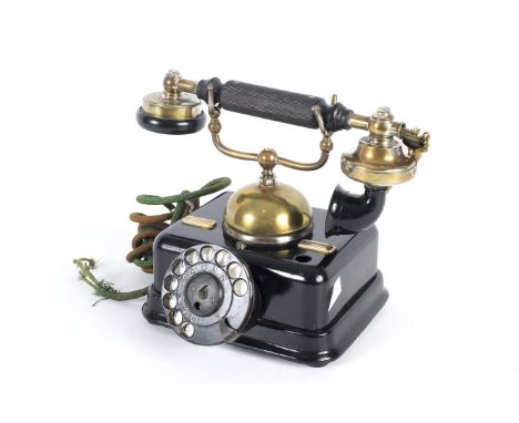 A Danish Kjobenhavns Telefon brass mounted cradle desk telephone. In a black metal case with rotary dial, brass bell and crad