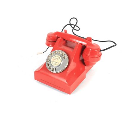 An ITI red rotary dial telephone. DJL 11044-A1, converted with BT plug