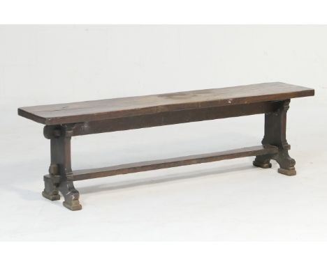 Old oak bench, 19th Century, single plank seat raised on chamfered splat supports united by a foot rest stretcher, width 152c