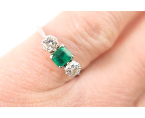 Emerald and diamond three stone ring, centred with a square cut emerald of approx. 0.25ct, in platinum claw mounts, flanked b