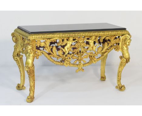 Italian style gilt metal console table, black granite top over a border of stiff acanthus leaves and openwork apron festooned