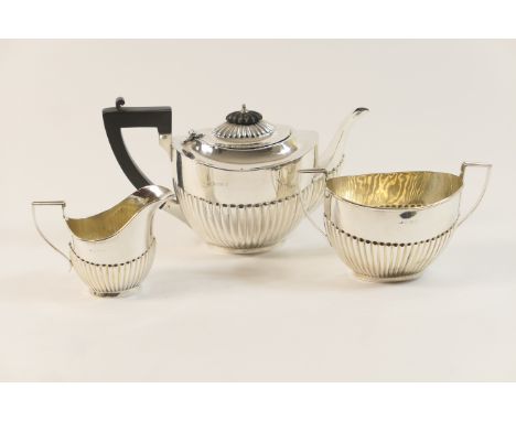 George V silver bachelor's three piece tea service, Birmingham 1919, comprising teapot, sugar basin and milk jug, each of hal