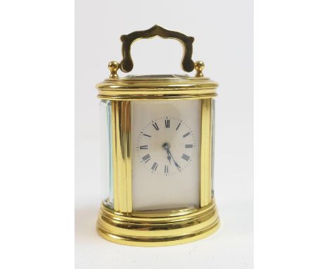 Miniature brass carriage timepiece, late 20th Century, oval form, white enamel dial with Roman numerals, height 8cm 