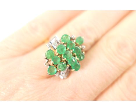 Emerald and diamond cluster ring, set with 13 round cut emeralds, total weight estimated as approx. 2.5cts, in claw mounts an