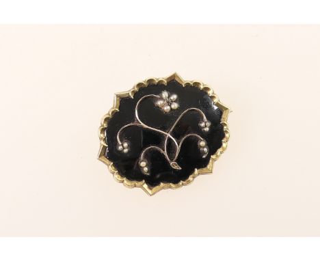 Victorian mourning brooch, shaped oval form inset with seed pearl flowers against a black enamelled ground and with locket in