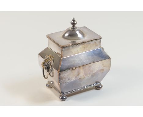 Edwardian electroplated tea caddy, rectangular baluster form with lions mask ring handles and hinged cover, raised on squat b