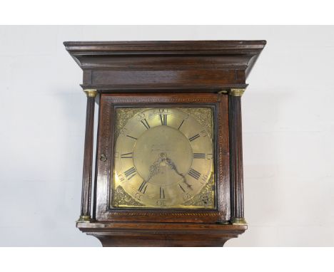 Thirty hour oak longcase clock, the hood with brass capped reeded columns flanking a 12'' brass dial, signed Baddely, Albrigh