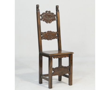 Continental walnut chair, first half 18th Century, the back surmounted with figural terminals and with two crossed splats car