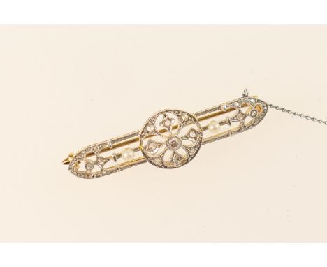 Late Victorian diamond and pearl bar brooch, Gothic inspired design centred with a round brilliant cut diamond of approx. 0.1