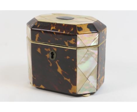 Regency tortoiseshell and mother of pearl tea caddy, canted rectangular form, the hinged cover with a silver inlaid vacant ca