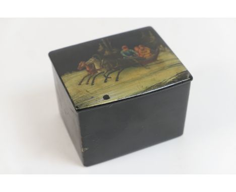 Russian papier mache tea caddy, circa 1900, rectangular form, the hinged cover decorated with a troika being drawn through a 