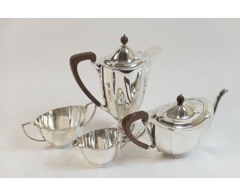 George V silver four piece tea service, Birmingham 1931/32, comprising teapot and footed hot water jug, each with composite f