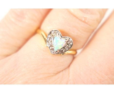 Opal and diamond cluster ring, centred with a heart shaped cabochon opal measuring approx. 5mm, bordered with tiny brilliant 