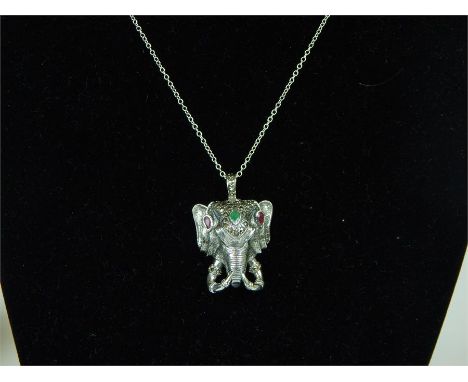 An unusual silver elephant necklace set with ruby and emeralds.