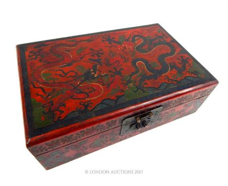 A Chinese red lacquered box, decorated to the lids with dragons chasing a flaming pearl, 10 x 29 x 19cm.
