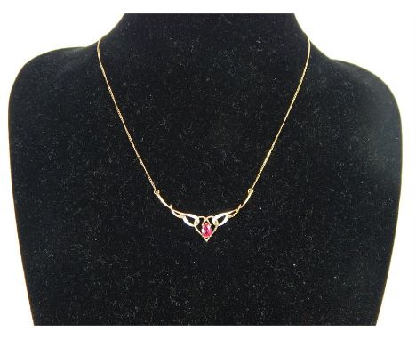 A 9 ct yellow gold, ruby and diamond necklace, composed of a central, oval-shaped, faceted ruby in a four-claw setting, flank