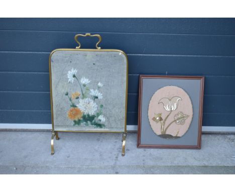 A heavy and painted 20th century brass mirror / fire screen together with an embroidered wall hanging (2). 
