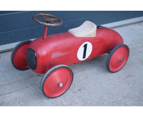 A vintage retro 20th century children?s tinplate racing car in a red colourway with number '1' to both sides. 76cm long. 