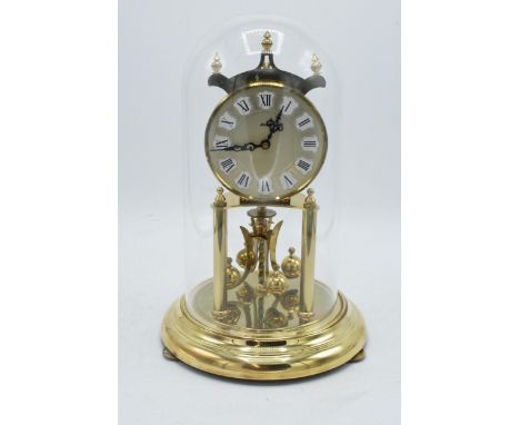 A 20th century anniversary clock with dome made by Kieninger &amp; Obergfell with key. Appears to be in working order. 28cm t