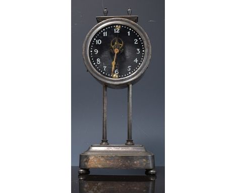 White metal cased mechanical gravity clock, glass dial, visible escapement, 27cms.