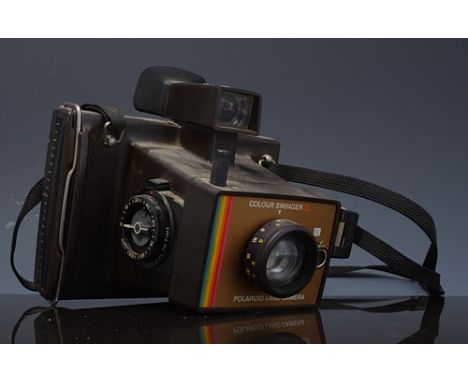 Rolleicord reflex camera, with booklet, a vintage cine camera and a Polaroid camera.