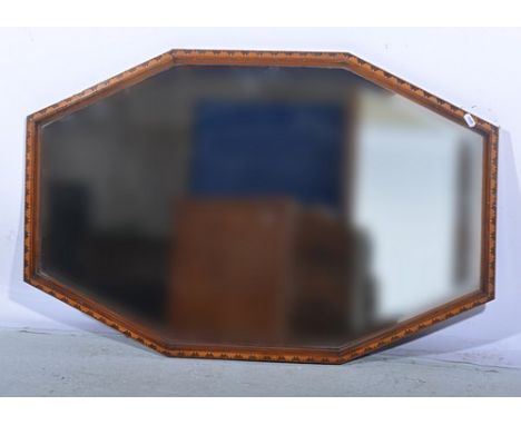 Octagonal wall mirror, beveled plate, the frame with parquetry work decoration, 55 x 90cms.