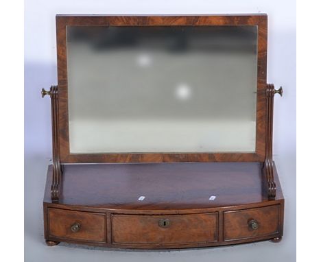 William IV mahogany toilet mirror, rectangular plate, scrolled support, bow-front platform with three drawers, width 64cms.