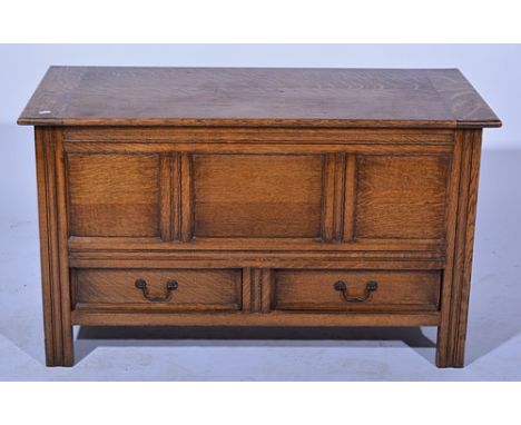 Oak mule chest, the top with pleated ends, three-panel front fascia over two drawers, width 105cms.