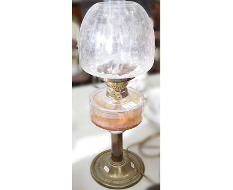 Brass oil lamp, clear glass reservoir, complete with shade and chimney, 61cms and a lacquered brass candlestick, adapted as a