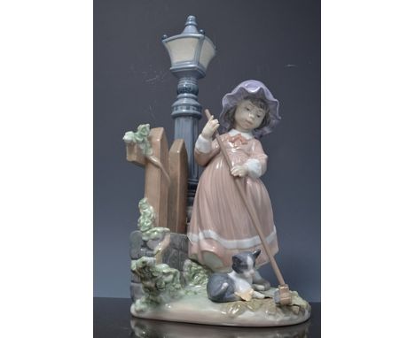 Lladro figure of a girl sweeping by  a lamp post with a kitten, 34cms, with a box.