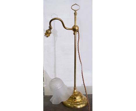 Adjustable brass student's lamp, with a frosted shade, 57cms, a glass inkwell and a brass-mounted blotter, (3).